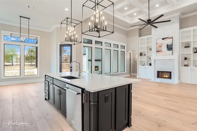 a kitchen with stainless steel appliances granite countertop a kitchen island hardwood floor and a sink