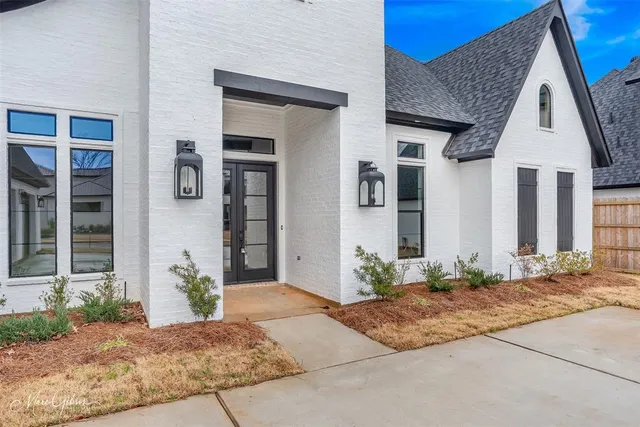 a front view of a house with potted plants