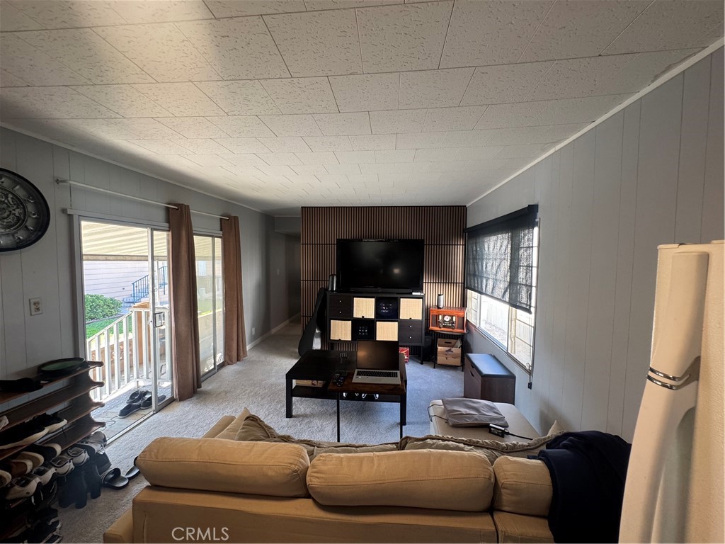 47 Fir Via Anaheim, CA 92801 - Photo 2 of 14 a living room with furniture and floor to ceiling window