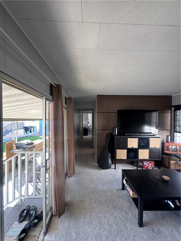 47 Fir Via Anaheim, CA 92801 - Photo 4 of 14 a living room with furniture a flat screen tv and a large window