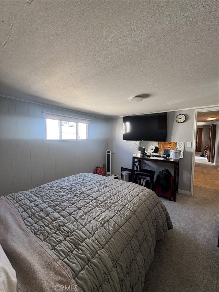 47 Fir Via Anaheim, CA 92801 - Photo 10 of 14 a bedroom with a bed and a flat screen tv