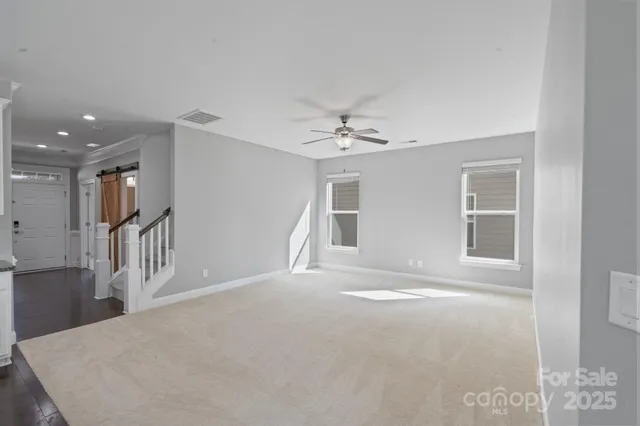 a kitchen with granite countertop white cabinets and stainless steel appliances