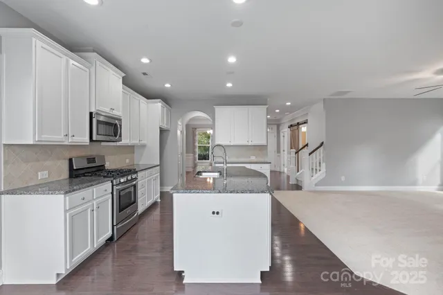 a view of hallway with sink and mirror