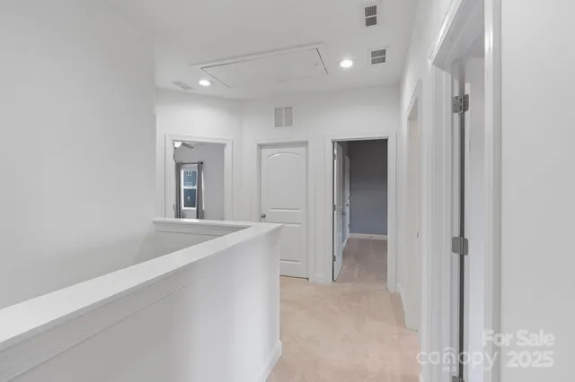 an empty room with closet and a chandelier fan