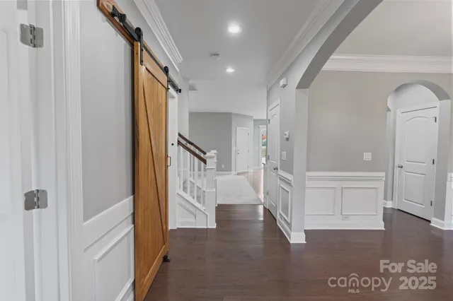 a view of entryway with wooden floor and stairs