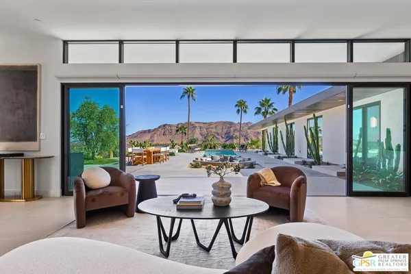 a outdoor living space with furniture and a fireplace