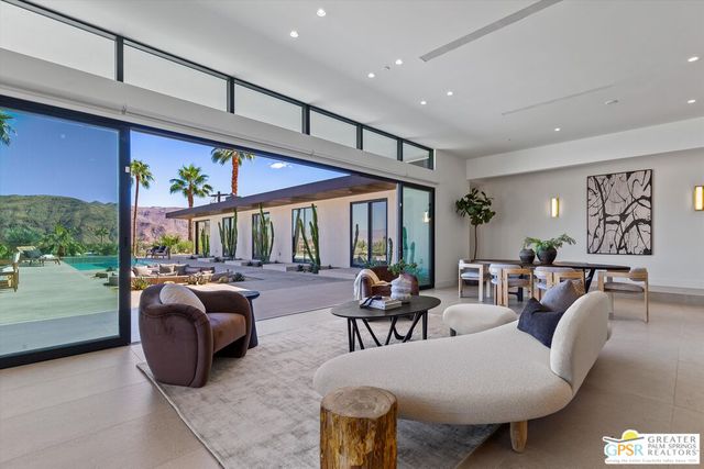 a bed sitting in front of a balcony