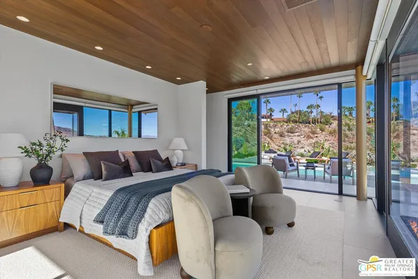 a bedroom with a bed and a television