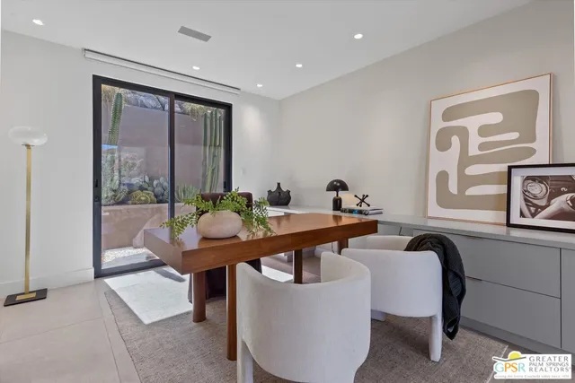 a view of a livingroom with workspace and a couch