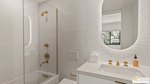 a view of a patio with table and chairs potted plants and large tree