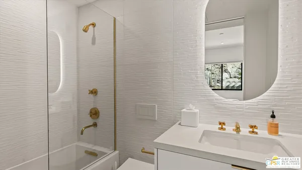 a bathroom with a sink a granite and shower