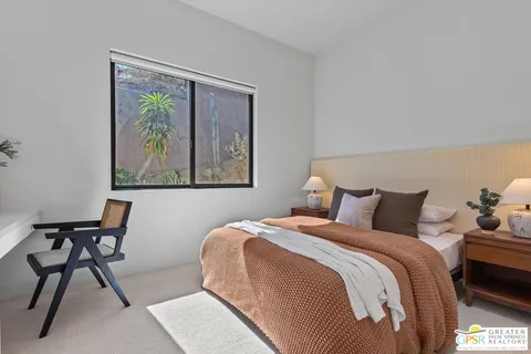 a front view of a house with sitting area and garden