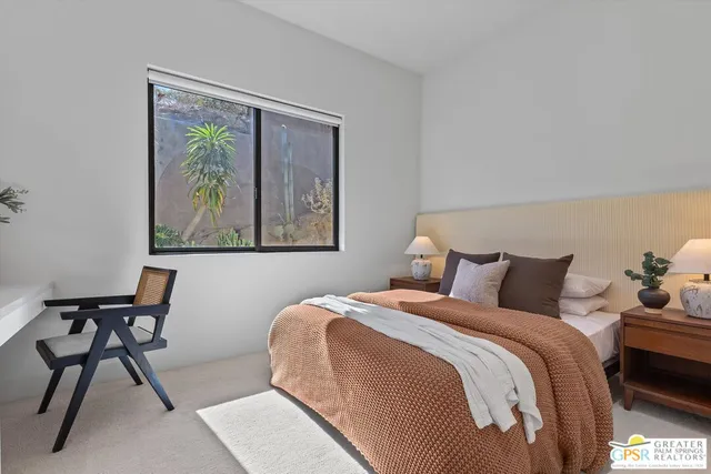 a front view of a house with sitting area and garden