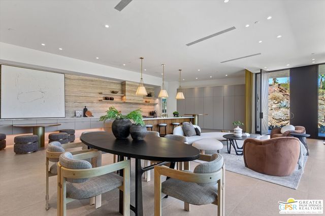 a view of a swimming pool with a table and chairs