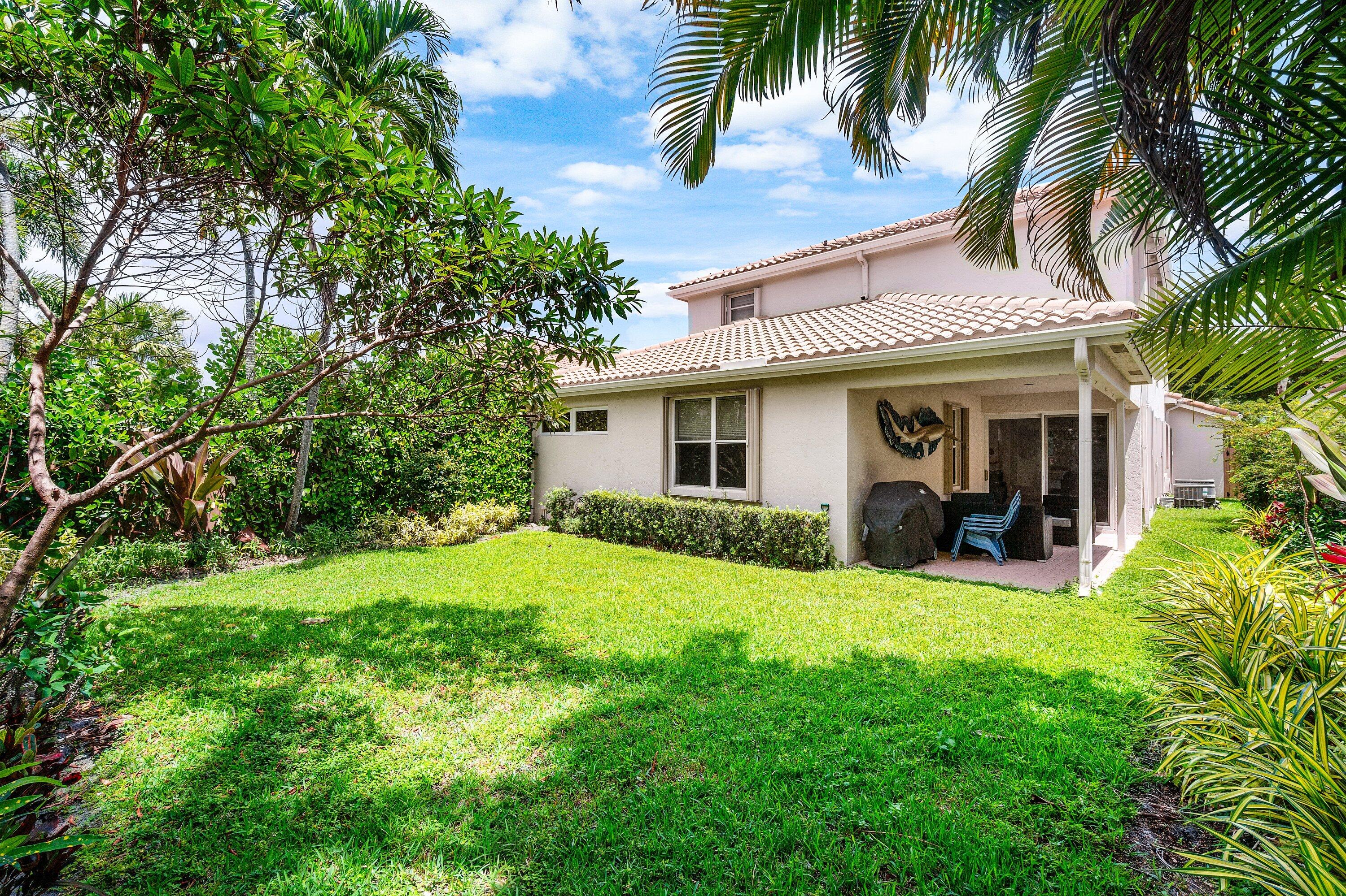 2404 Northwest 67th Street Boca Raton, FL 33496 - Photo 38 of 74 a view of a house with a yard patio and a small yard