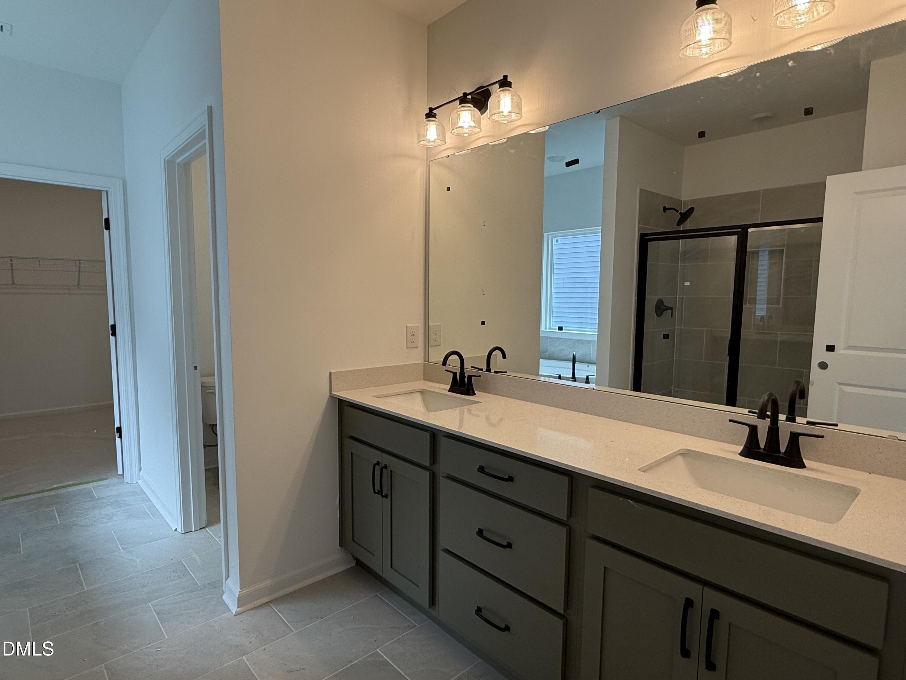 508 Contempo Court, Unit 39 Rolesville, NC 27571 - Photo 12 of 37 a bathroom with a double vanity sink mirror and double