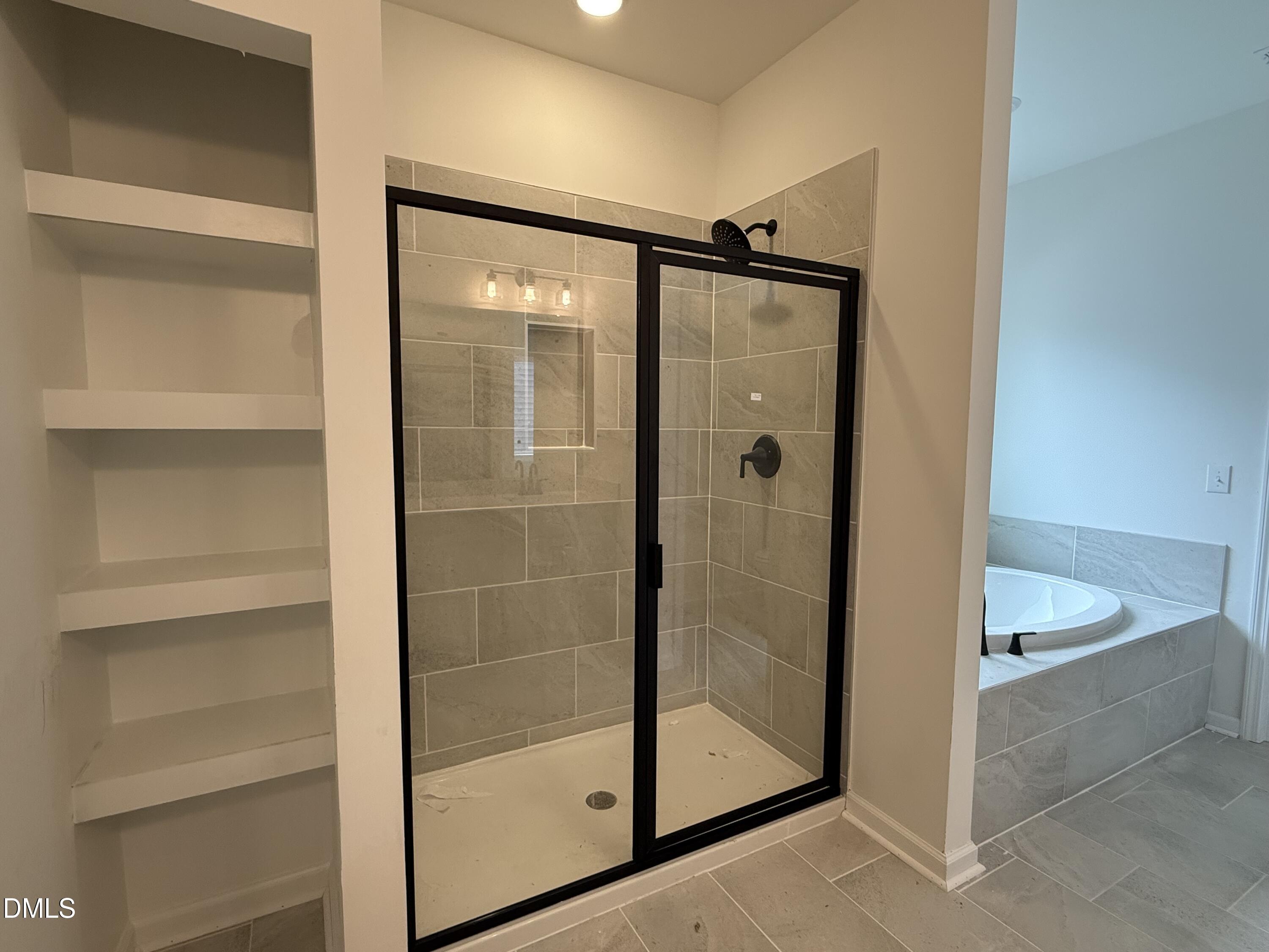 508 Contempo Court, Unit 39 Rolesville, NC 27571 - Photo 13 of 37 a bathroom with a glass shower door