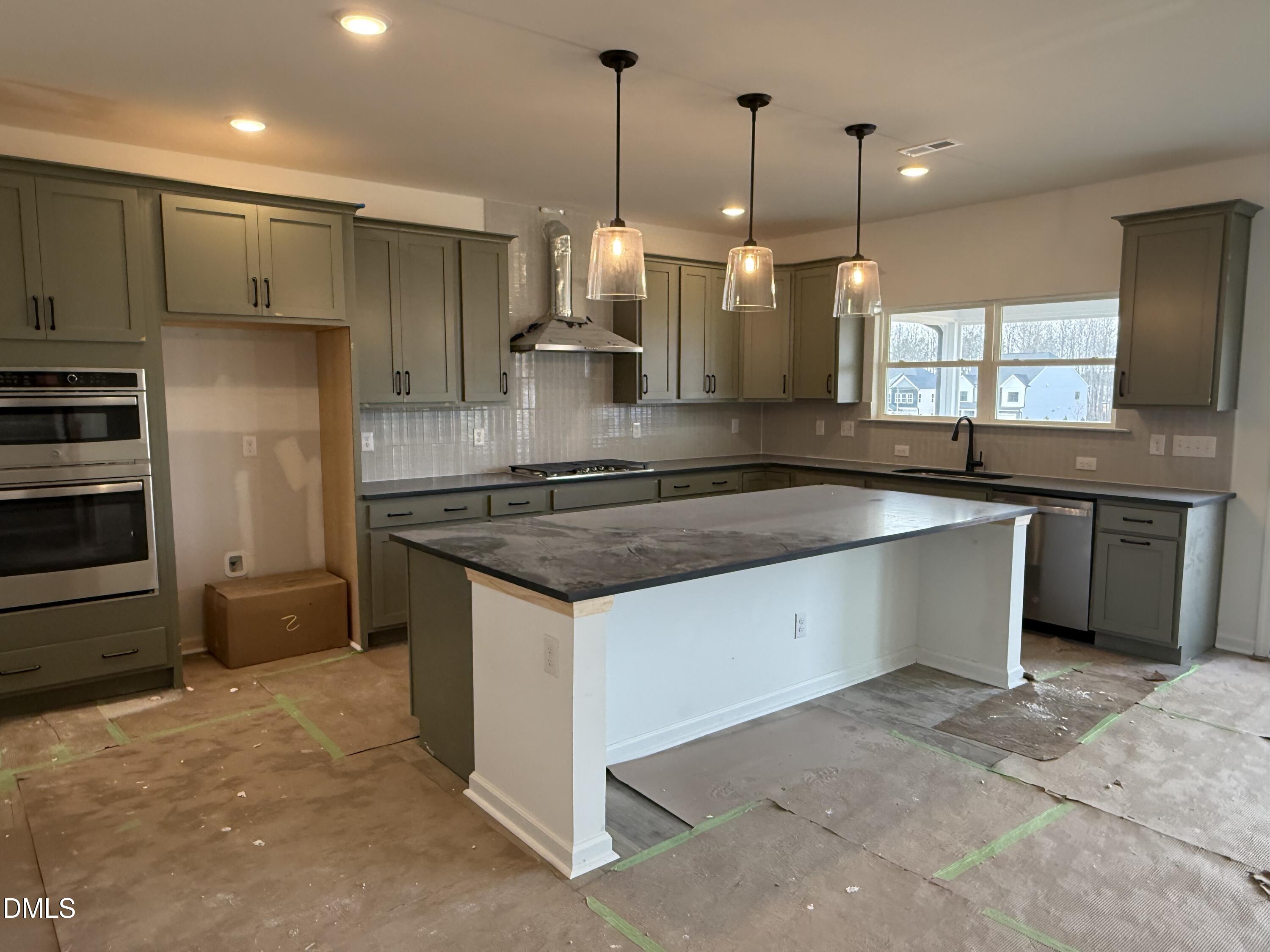 508 Contempo Court, Unit 39 Rolesville, NC 27571 - Photo 4 of 37 a kitchen with stainless steel appliances granite countertop a sink a stove and a refrigerator