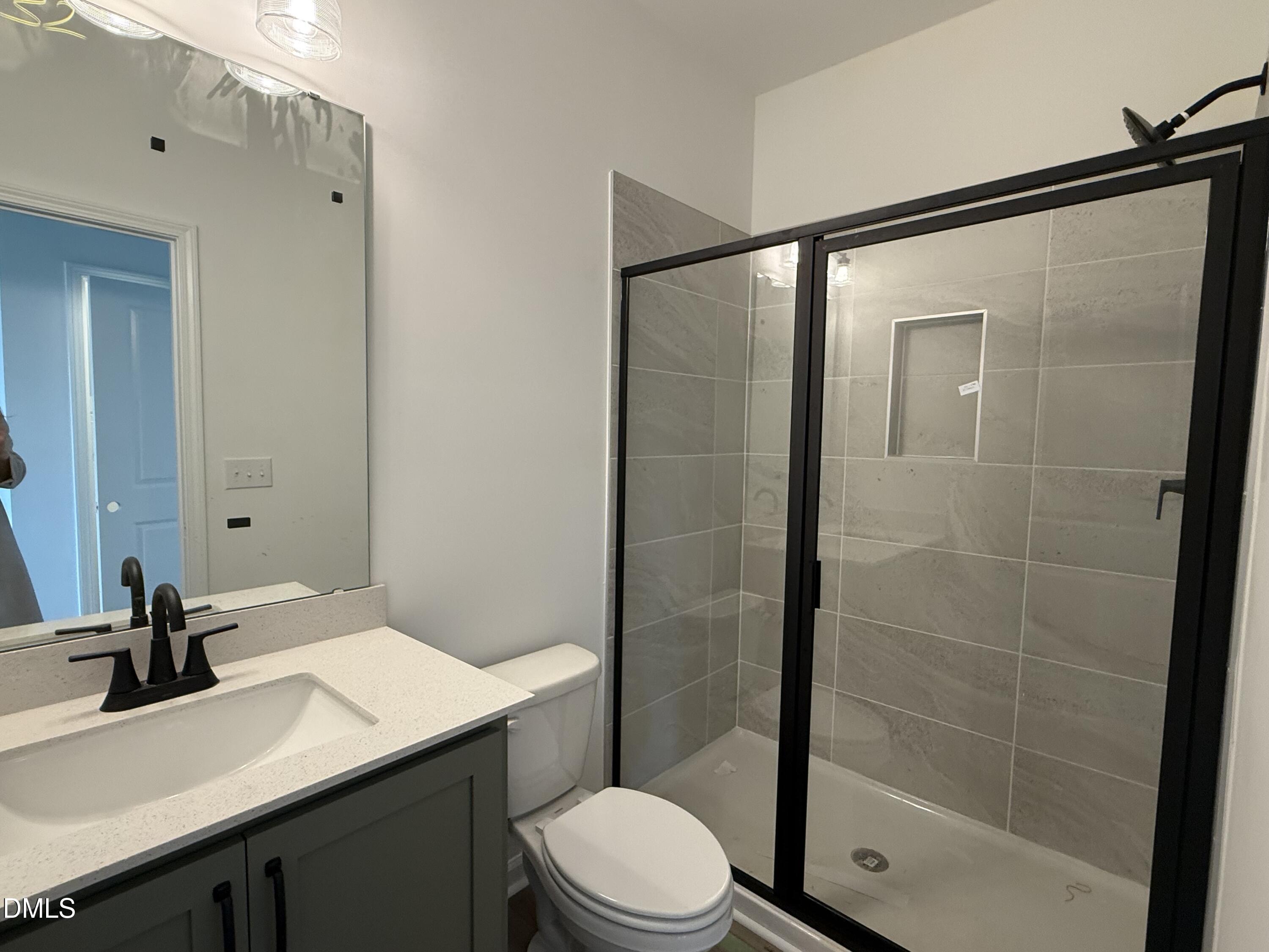 508 Contempo Court, Unit 39 Rolesville, NC 27571 - Photo 9 of 37 a bathroom with a sink a toilet and shower