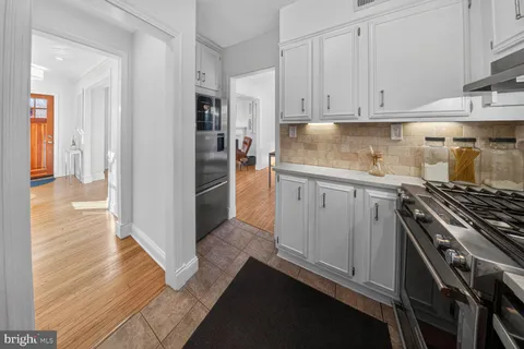 a kitchen with granite countertop a stove and a refrigerator