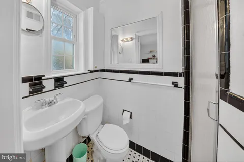 a bathroom with a sink a mirror and a toilet