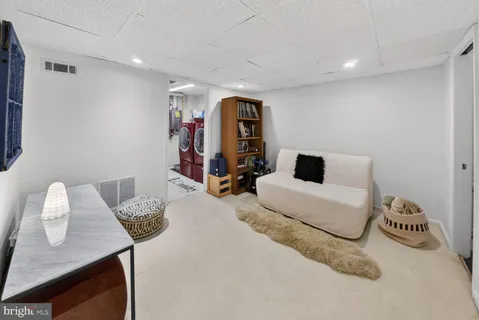 a bedroom with furniture and a lamp