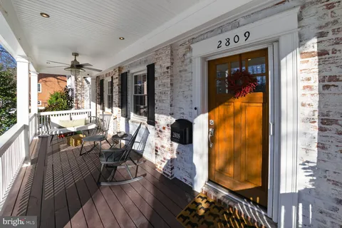 a view of balcony with furniture and wooden floor