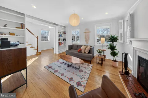 a living room with furniture fireplace and dining table