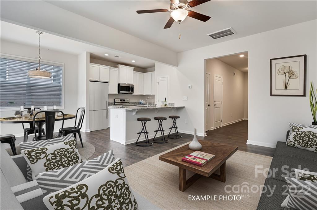 a living room with furniture and a rug