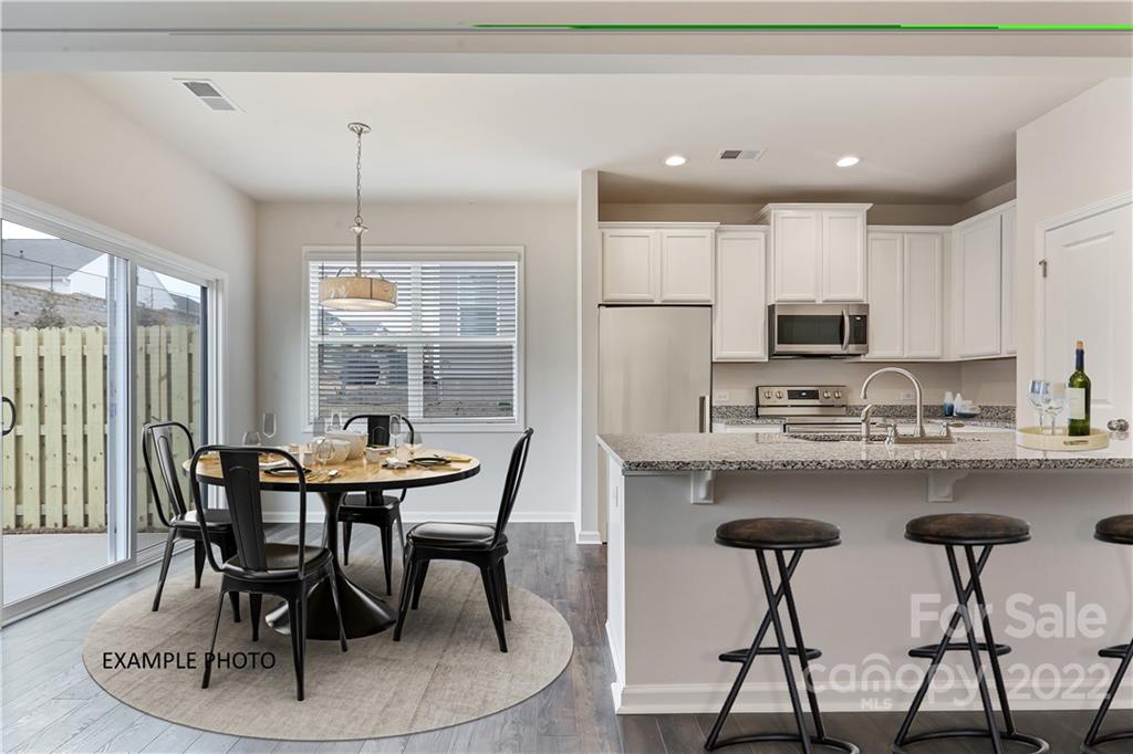 3738 Yorkshire Place, Unit 52 Terrell, NC 28682 - Photo 3 of 9 a view of a dining room with furniture and wooden floor