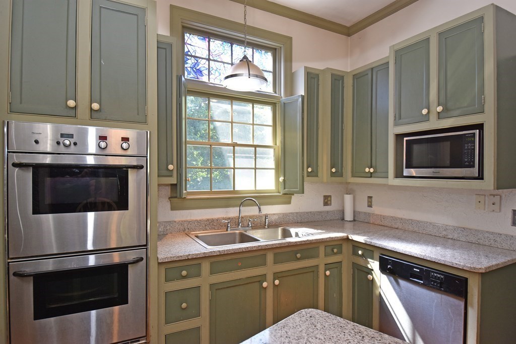 52 Central Street Gardner, MA 01440 - Photo 14 of 38 a kitchen with a sink stove and microwave