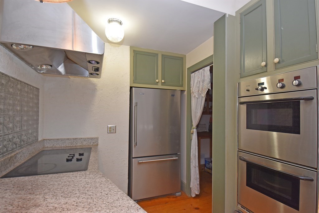 52 Central Street Gardner, MA 01440 - Photo 15 of 38 a metallic refrigerator freezer sitting in a kitchen