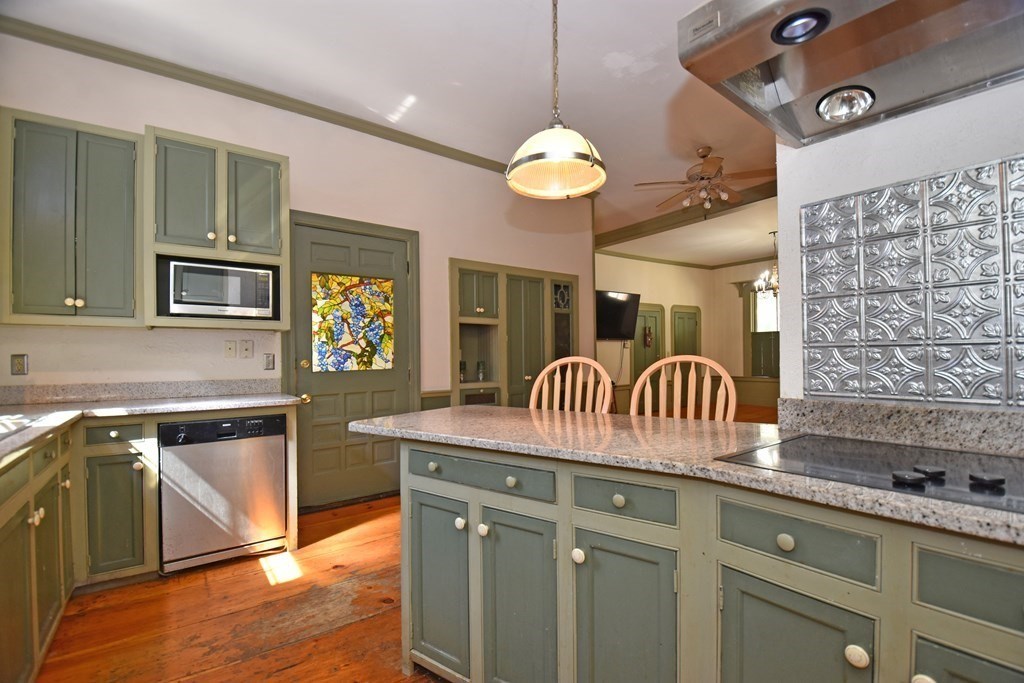 52 Central Street Gardner, MA 01440 - Photo 16 of 38 a kitchen with a kitchen island sink stove and cabinets