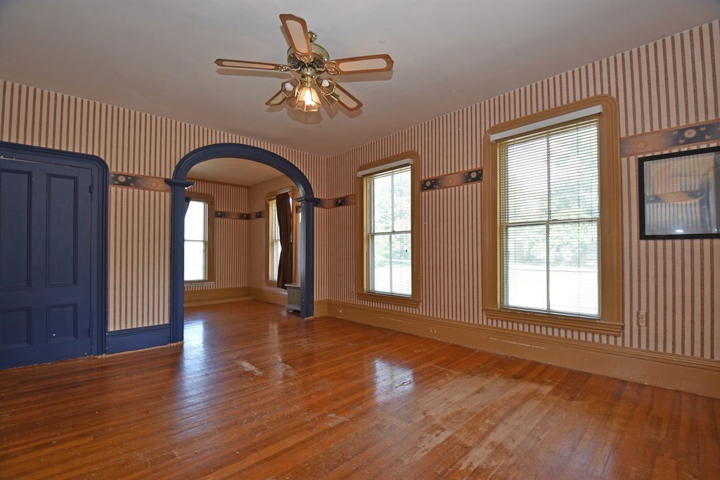 52 Central Street Gardner, MA 01440 - Photo 20 of 38 an empty room with wooden floor fan and windows