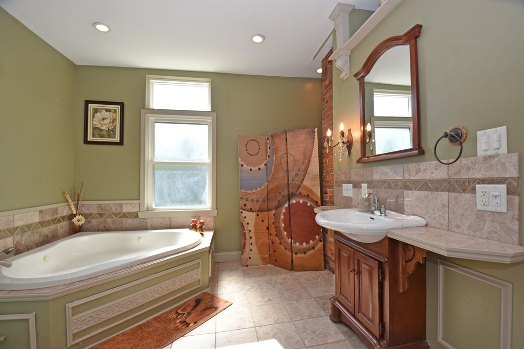 52 Central Street Gardner, MA 01440 - Photo 24 of 38 a spacious bathroom with 2 sink tub and a mirror