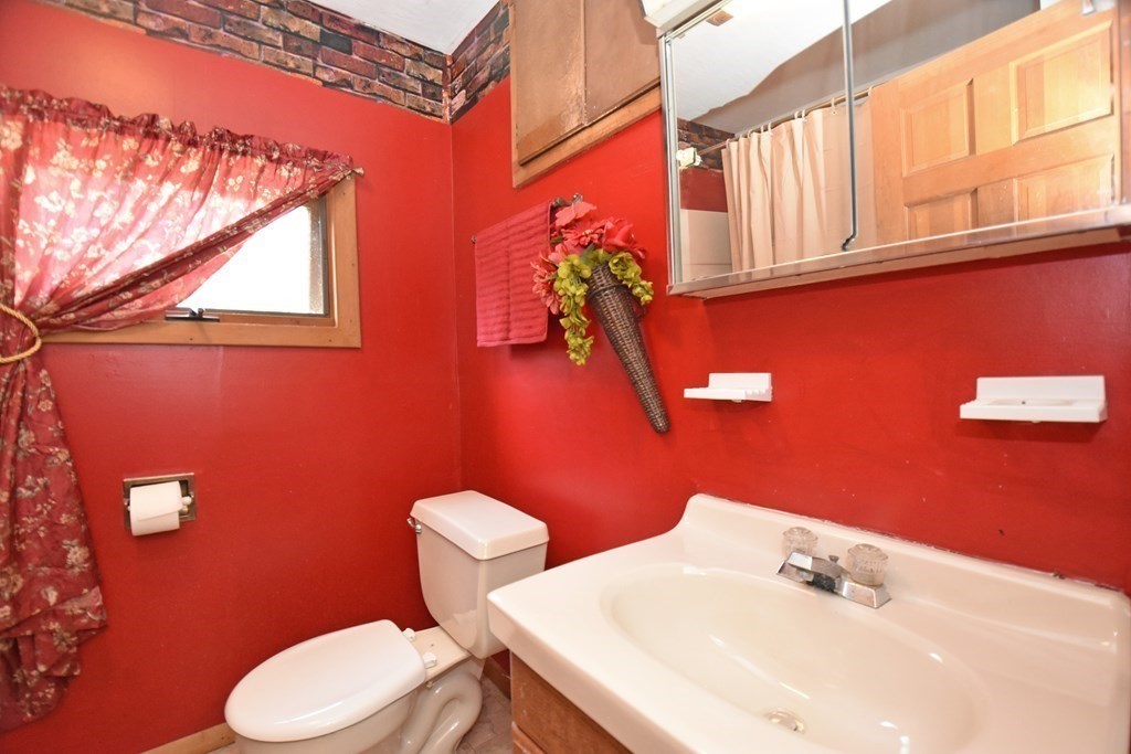 52 Central Street Gardner, MA 01440 - Photo 34 of 38 a bathroom with a sink a toilet and mirror