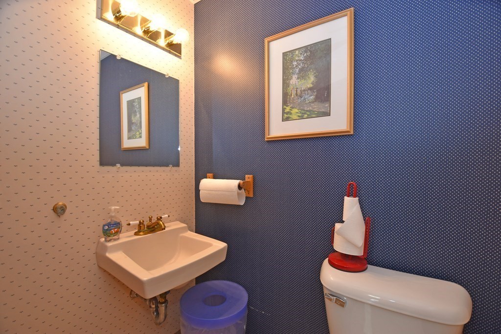 52 Central Street Gardner, MA 01440 - Photo 36 of 38 a bathroom with a toilet sink and mirror