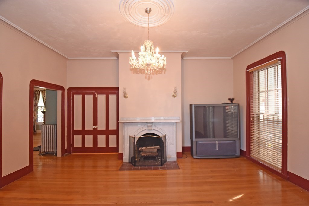 52 Central Street Gardner, MA 01440 - Photo 8 of 38 a view of a livingroom with a fireplace window and wooden floor