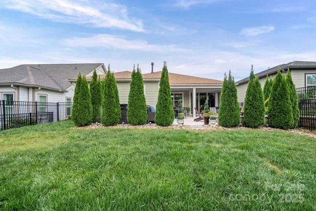 a view of a house with backyard garden and plants