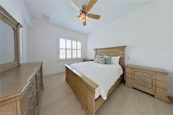 a bedroom with a bed dresser and a window