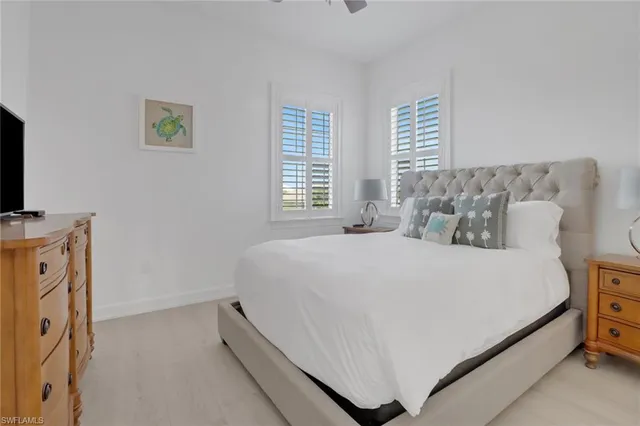 a bed sitting in a bedroom next to a window