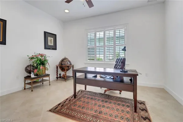 a living room with furniture a rug and a potted plant