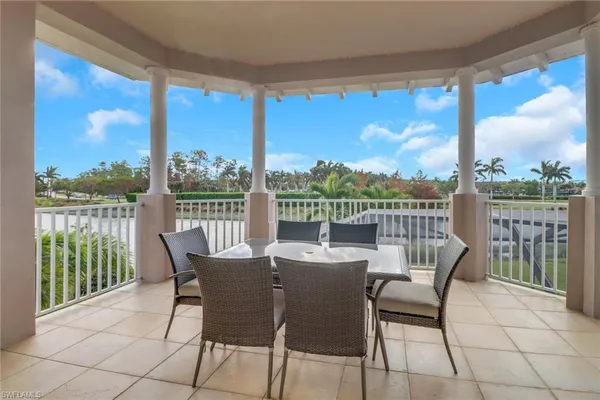 a view of a balcony with a table and chairs