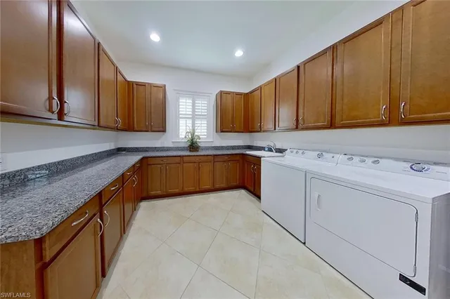 a kitchen with granite countertop a sink stove and cabinets