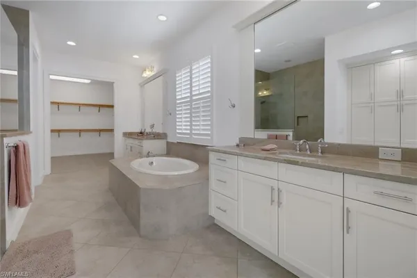 a bathroom with a granite countertop sink mirror and toilet