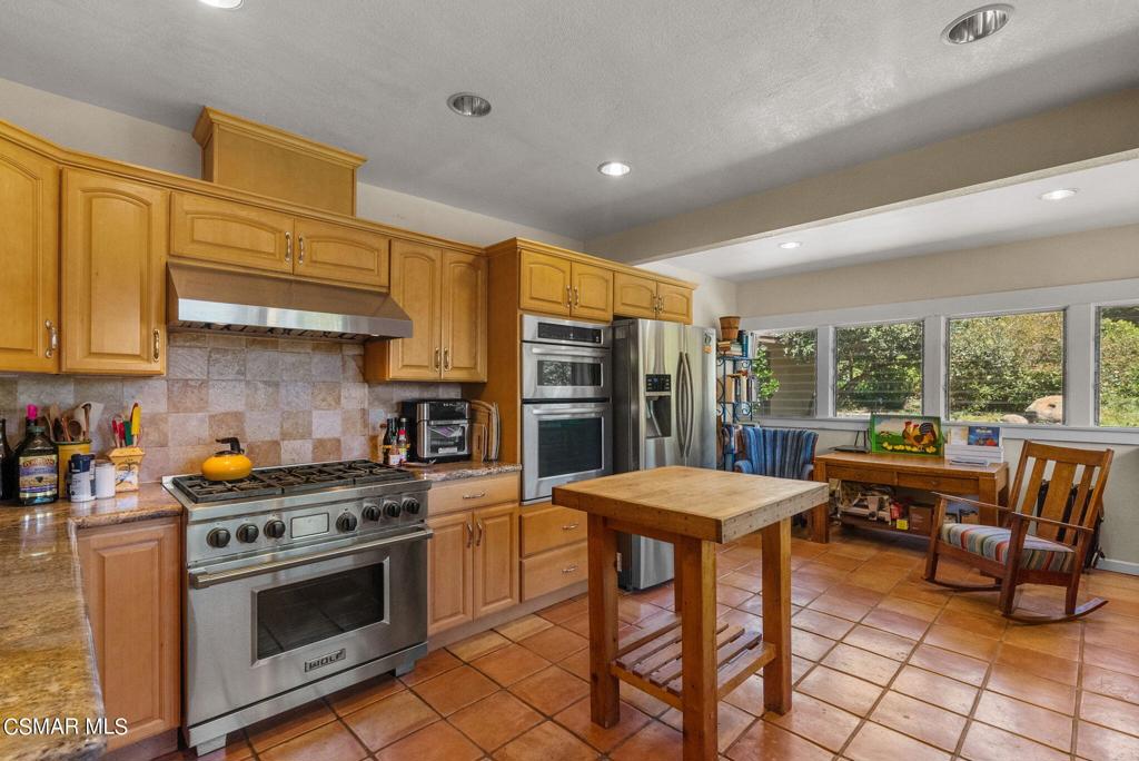 5682 Pine Grove Road Santa Paula, CA 93060 - Photo 20 of 53 a kitchen with a stove a refrigerator and wooden cabinets