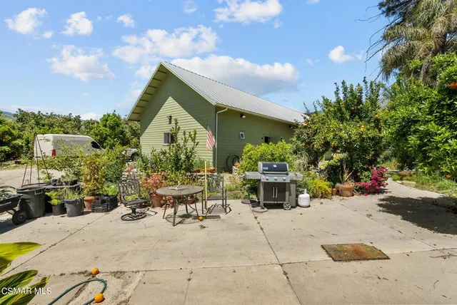 a view of a patio with table and chairs and potted plants