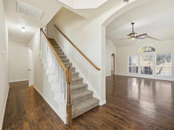 a view of entryway and hall with wooden floor