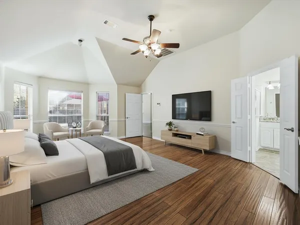 a bedroom with a bed and a flat screen tv