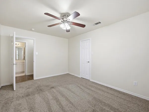 a view of an empty room with a fan
